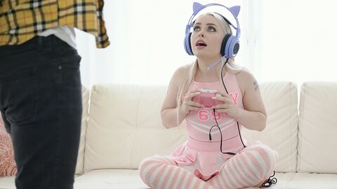 Cosplaying ash-blonde wearing headphones while gaming